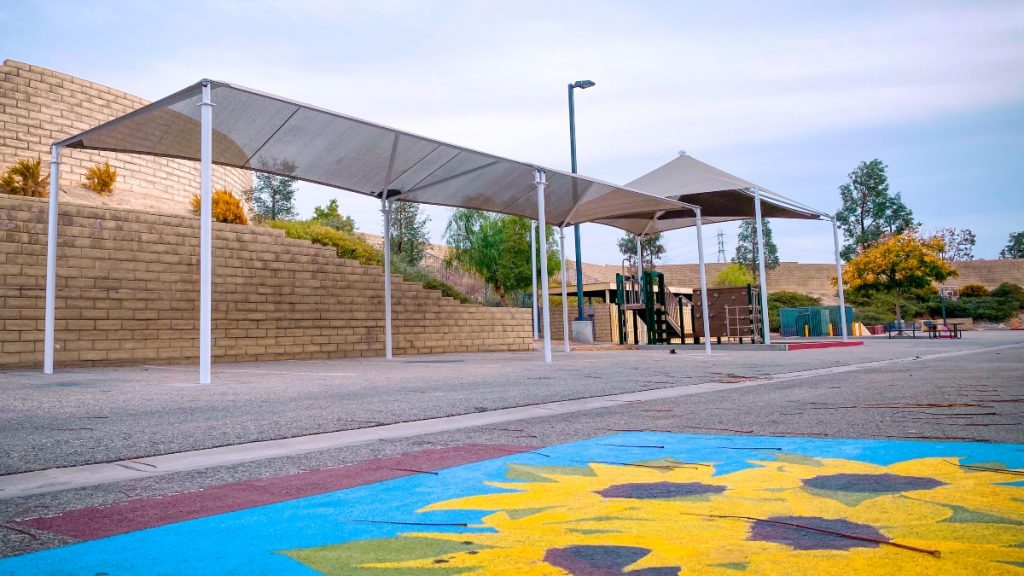 SCVi shade structure in play area behind school building