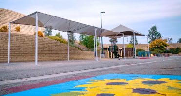 SCVi shade structure in play area behind school building